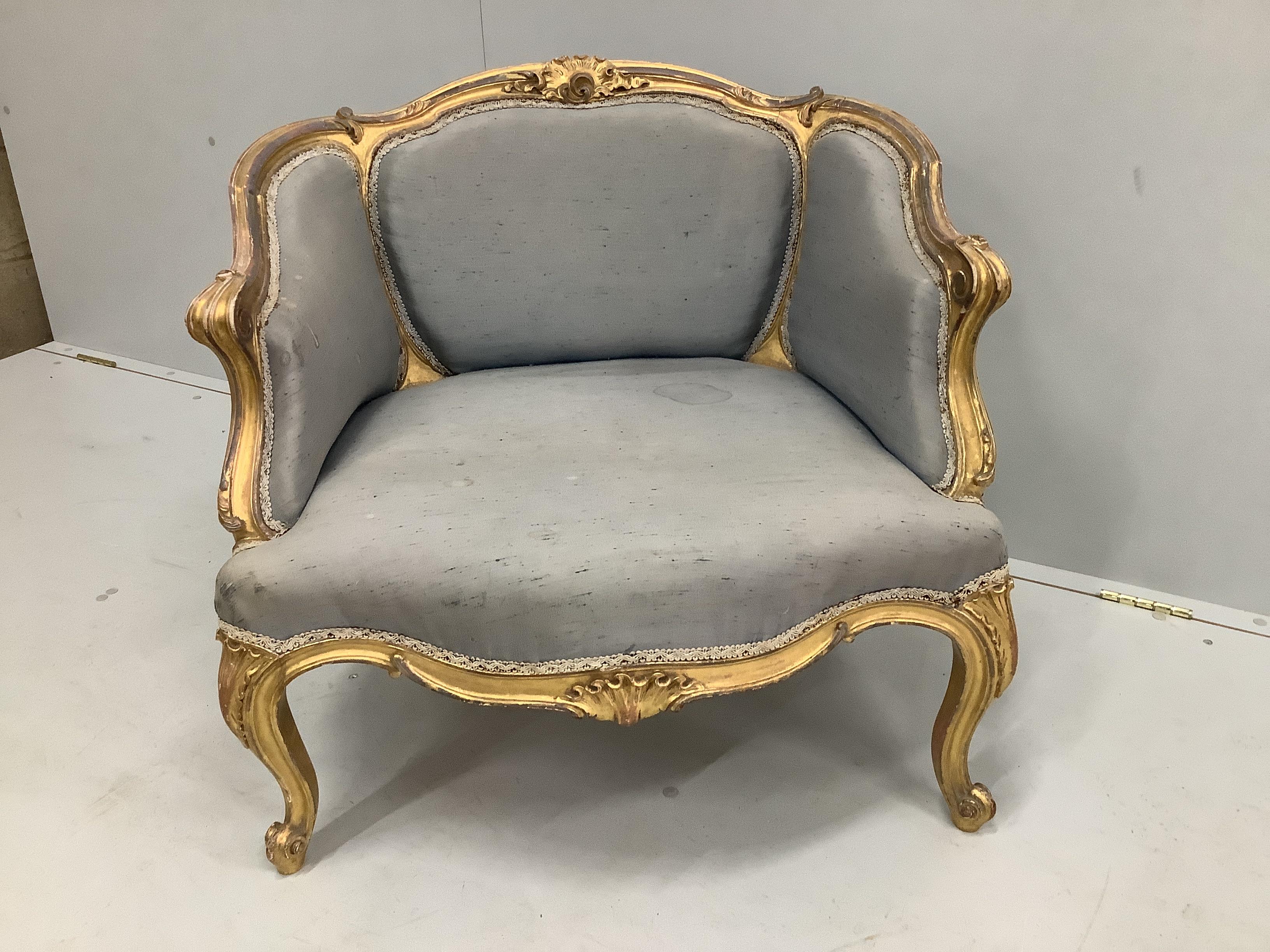 A Victorian carved giltwood and composition upholstered salon chair, width 70cm, depth 60cm, height 67cm